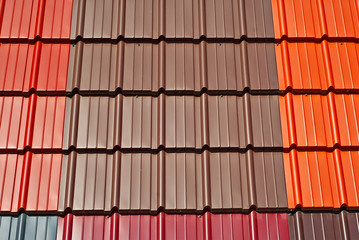 Roof of metal tiles. Tile texture close up. Orange and brown roof.