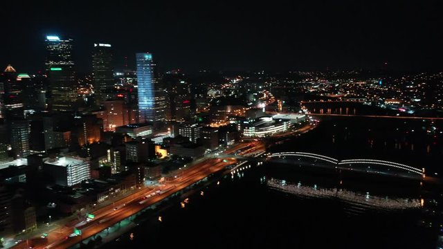 Downtown Pittsburgh Illuminated City Skyline PPG Building at Night Aerial with Water Reflection 4K 