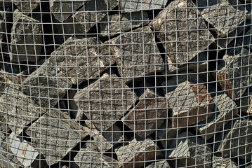 Cobblestone texture. The sidewalk is evenly folded into a wire mesh. Marble and granite drainage system closeup.