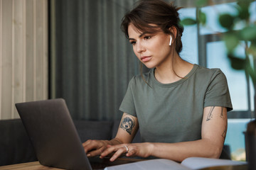Attractive young woman working on laptop computer