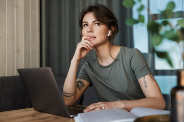 Attractive young woman working on laptop computer