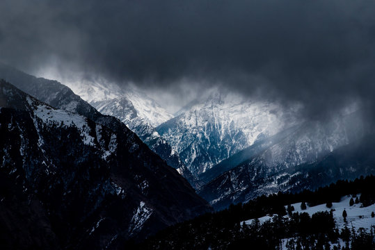 Dark Clouds over snow clas mountains