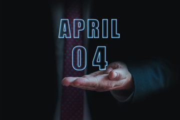 april 4th. Day 4 of month, announcement of date of  business meeting or event. businessman holds the name of the month and day on his hand.. spring month, day of the year concept