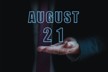 august 21st. Day 20 of month, announcement of date of  business meeting or event. businessman holds the name of the month and day on his hand.. summer month, day of the year concept