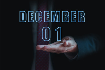 december 1st. Day 1 of month,  announcement of date of  business meeting or event. businessman holds the name of the month and day on his hand.. winter month, day of the year concept