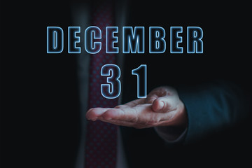 december 31st. Day 31of month, announcement of date of  business meeting or event. businessman holds the name of the month and day on his hand.. winter month, day of the year concept
