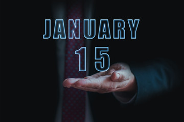 january 15th. Day 15 of month, announcement of date of  business meeting or event. businessman holds the name of the month and day on his hand.. winter month, day of the year concept