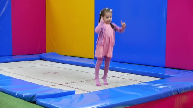 Little Kid Girl Jumping On Trampoline And Then Jump To Pool