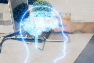 Man with computer background with brain theme hologram. Concept of brainstorm. Double exposure.