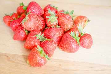 Strawberries on wooden table, natural light