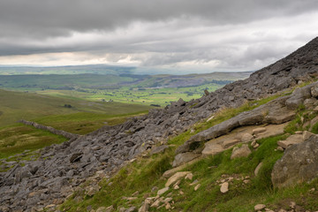 Fototapeta na wymiar Pen-y-ghent or Penyghent is a fell in the Yorkshire Dales, England. It is the lowest of Yorkshire's Three Peaks at 2,277 feet; the other two being Ingleborough and Whernside