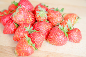 Strawberries on wooden table, natural light