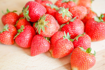 Strawberries on wooden table, natural light