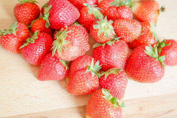 Strawberries on wooden table, natural light