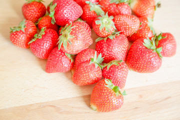 Strawberries on wooden table, natural light
