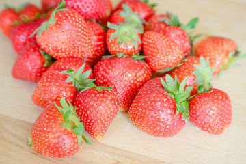 Strawberries on wooden table, natural light