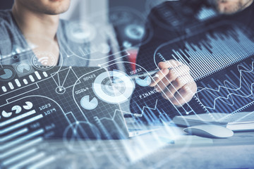 Technology theme hologram with man working on computer on background. High tech concept. Multi exposure.