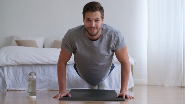 Family fitness at home, Father coach, Sports kid, Fun gymnastics. Young man push up from the floor at home