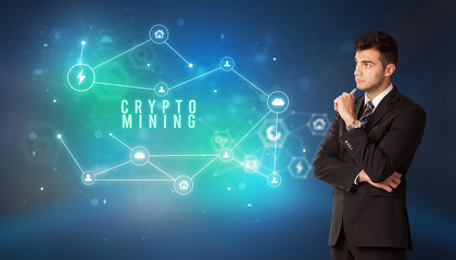 Businessman in front of cloud service icons with CRYPTO MINING inscription, modern technology concept