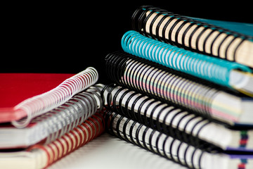 pile of spiral wire notebooks