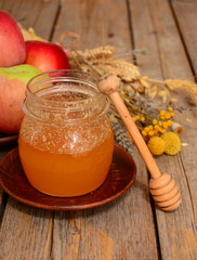 Jars of honey with apples on wooden table. Harvest of ripe apples and honey. Church celebration of the apple feast day. harvest concept