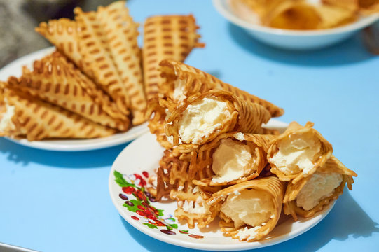 Yellow waffle rolls with white curd cream