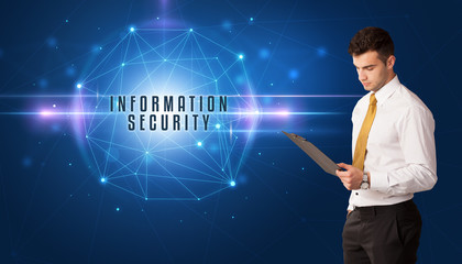 Businessman thinking about security solutions with INFORMATION SECURITY inscription