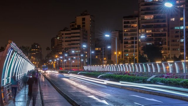 Villena Bridge with traffic and partial City view in the Background night timelapse, Lima, Peru. Cars and people moves on it