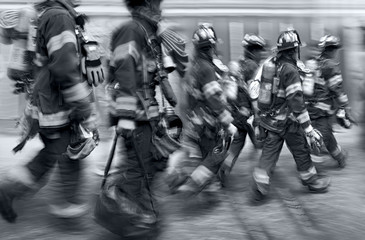fire trucks and firefighters brigade in the city in monochrome blue tonality