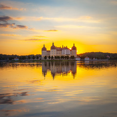 Fototapeta na wymiar Beautiful evening panorama of Moritzburg Baroque palace surrounded by a lake.