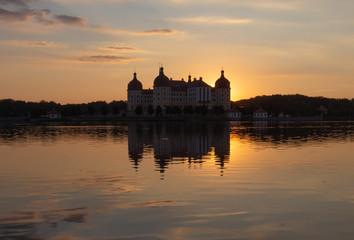 Fototapeta na wymiar Beautiful evening panorama of Moritzburg Baroque palace surrounded by a lake.