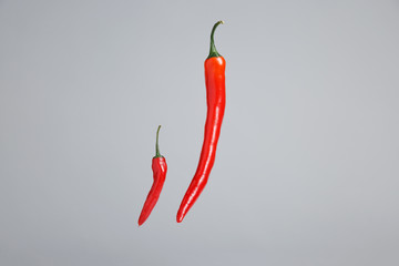 Red hot peppers small and large on a beautiful background