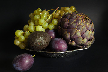 Still life with artichokes, grapes and plums