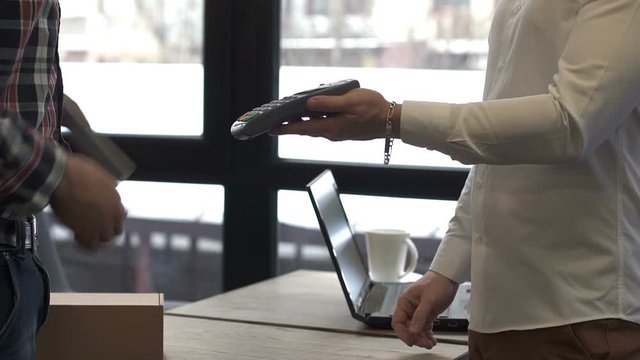Contactless payment for a parcel with a smartphone. NFS technology.
