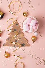 christmas cards and tree decorations on pink background.