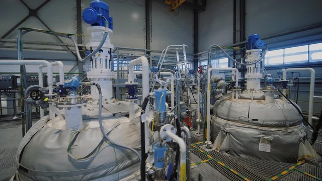 Refinery factory inside. Equipment, steel tanks and boilers for chemical mixing