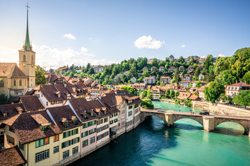 Fototapeta na wymiar Scenic cityscape of Bern at sunset with untertorbrucke bridge over Aare river and Nydegg church view with dramatic light in Bern old town Switzerland