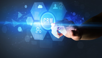 Hand touching CRM inscription, new technology concept