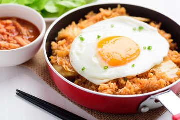 Korean food, Kimchi fried rice with fried egg in small cooking pan and chopsticks ready to eating