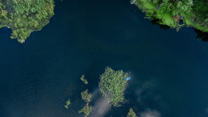 Drone photo over beautiful lake with green trees