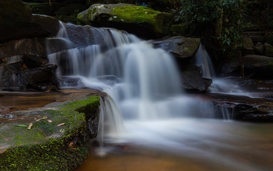 Water and rock cascade in tropical rainforest.