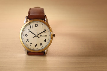Wristwatch on wooden table