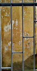 Behind ferrous prison there is a wall. Kind from a window in clink. After a window there is a...