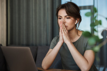 Attractive young woman working on laptop computer