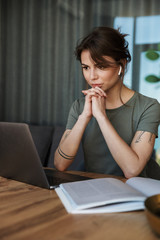 Attractive young woman working on laptop computer