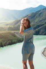 Domestic tourism, travel, lesure and freedom concept after pandemic- woman on the confluence of two rivers Katun and Chuya in Altai mountains, beauty summer day