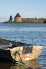 Old boat in the reeds overlooking the Oreshek Fortress on Ladoga in St. Petersburg