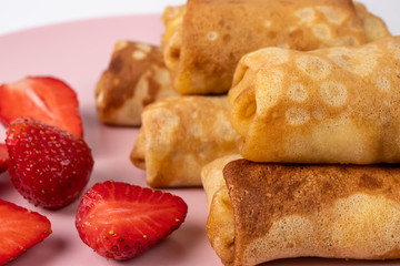 Wheat flour pancakes with strawberries. Sweet homemade pastries for breakfast. With sugar.