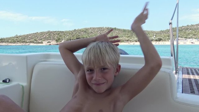 Young kid with real emotions looking and smiling to camera.
