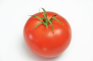 Ripe fresh tomato on a bright white background